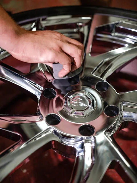 A pad working between the spokes of a chrome wheel