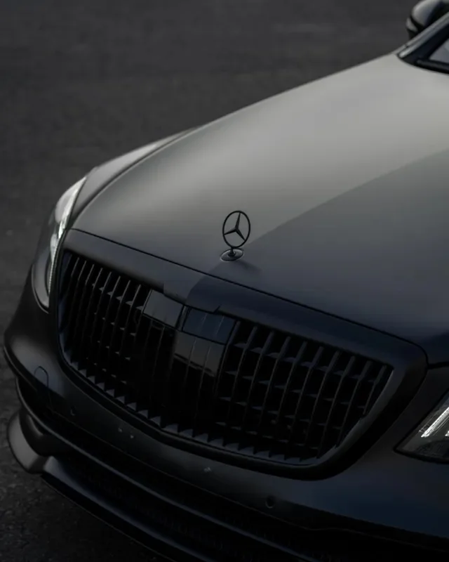 Hood and grille of a matte black sedan