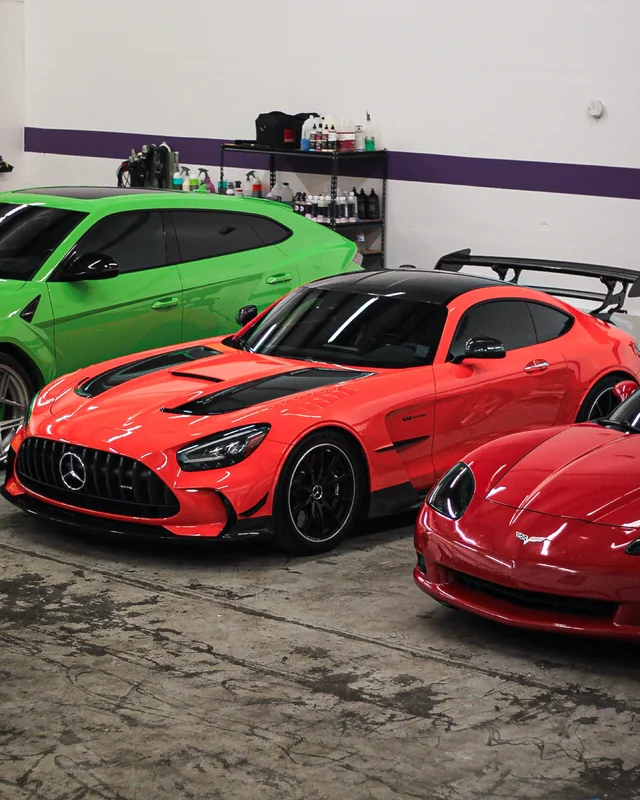 Three cars side by side on the shop floor
