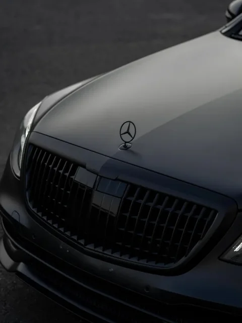 Hood and grille of a matte black sedan