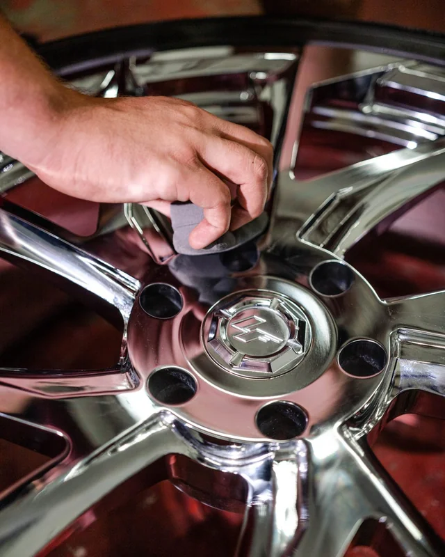 A pad working between the spokes of a chrome wheel